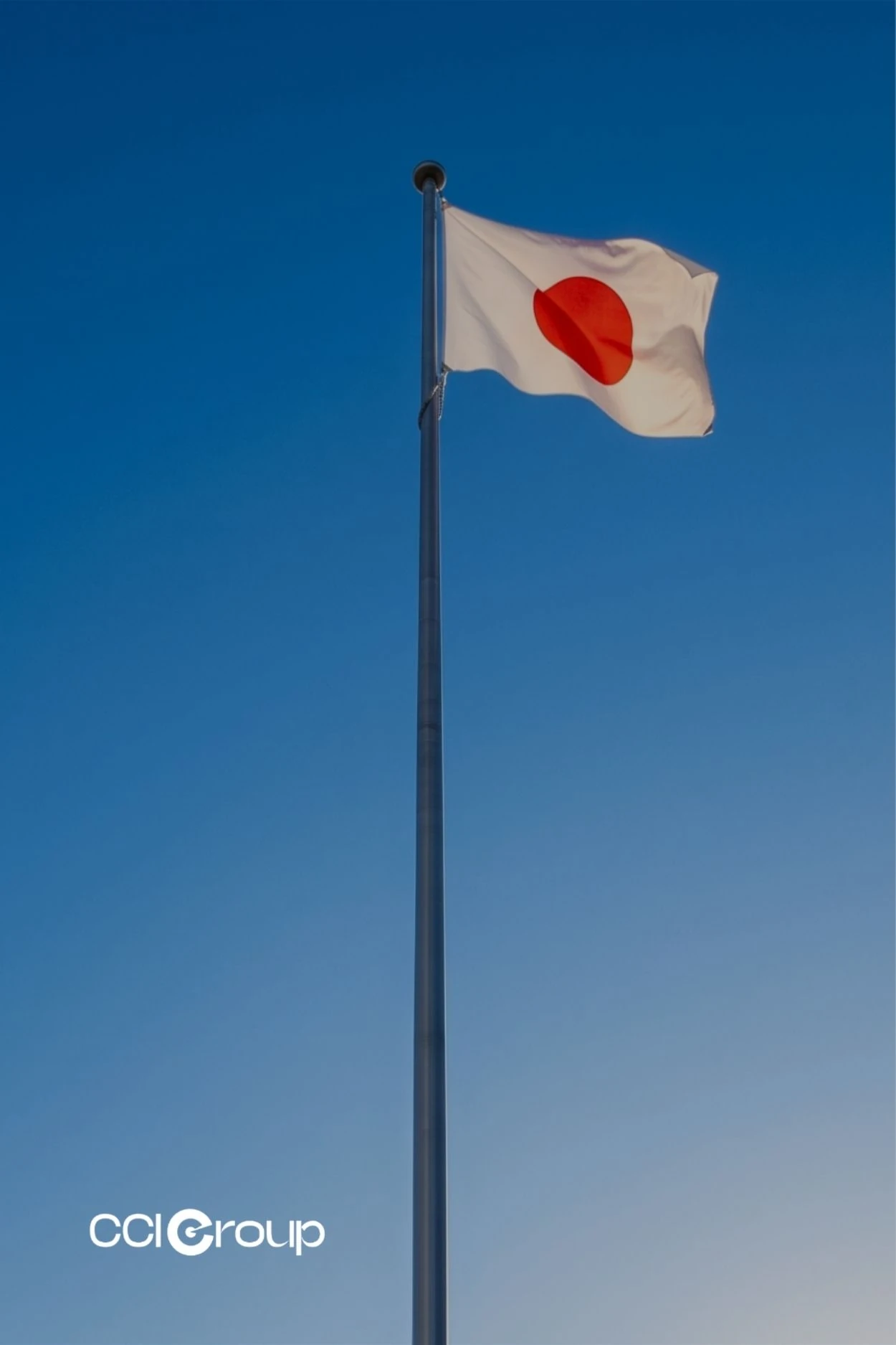 Japanese national flag with red sun disc waving against a clear blue sky, representing CCI Group's Japanese translation services.